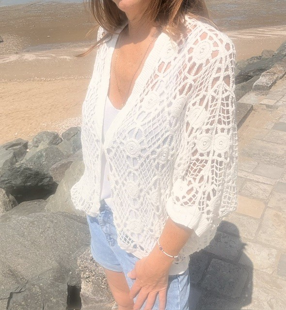 Gilet femme Boho en crochet boutonné, style bohème chic avec maille ajourée et coupe féminine tendance.