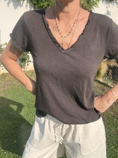Top femme à manches courtes avec col V et finitions franges, style bohème chic, idéal pour une tenue estivale et élégante et décontractée